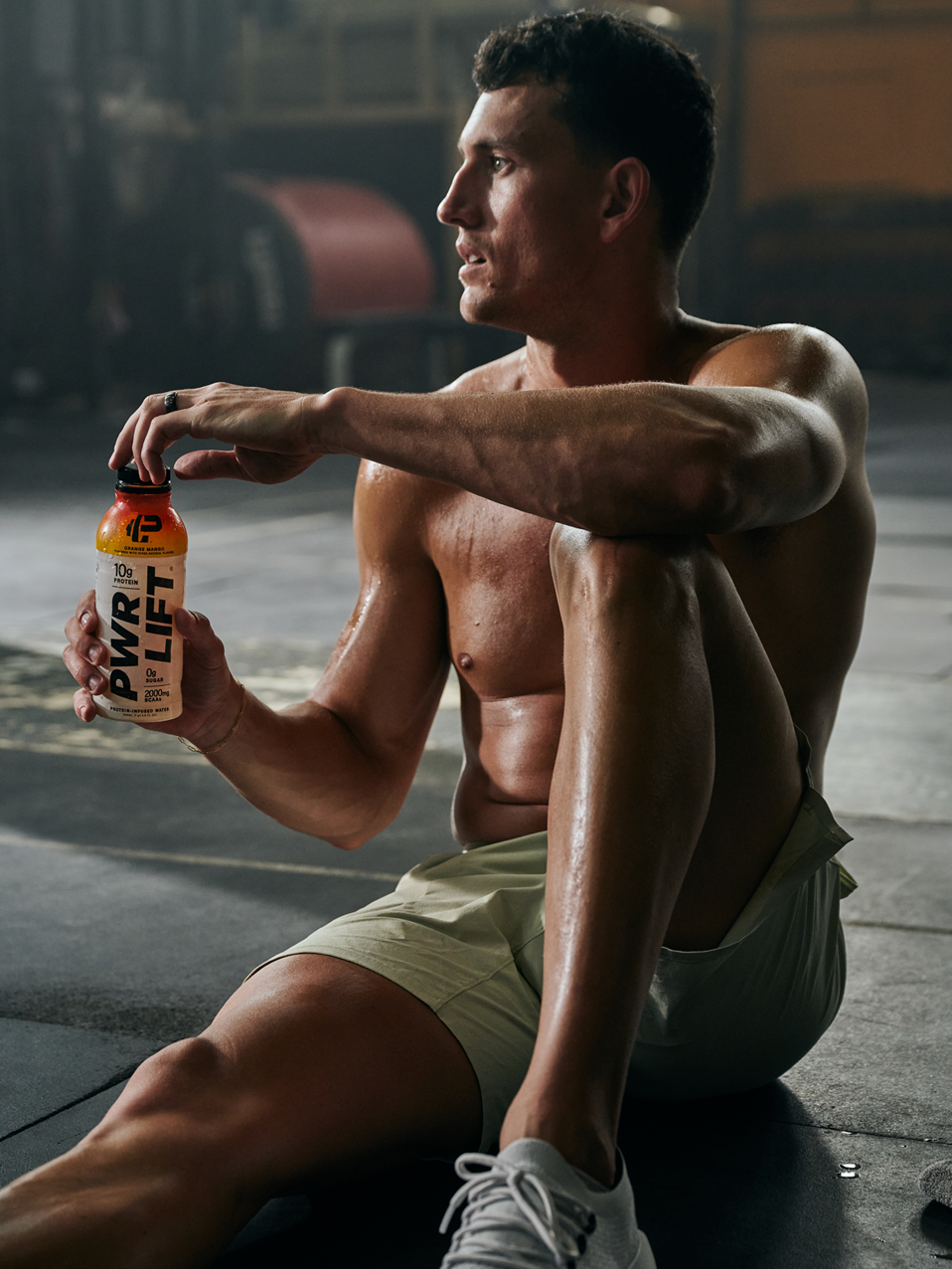 A man resting from his workout with a PWR LIFT Bottle